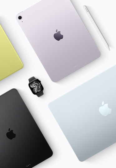 A top down view of different colored Mac and iPad devices, with a black Apple Watch in the center.